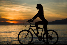 Sexy Woman Silhouette With Bicycle With Sunset And Seat