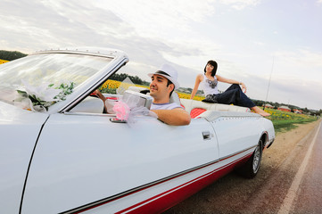 beautiful couple in love with the car