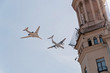 Ilyushin Il-78 (Midas) aerial refueling tanker and Tupolev Tu-160 (Blackjack) supersonic variable-sweep wing heavy strategic bomber demonstrate refueling in sky over building tower
