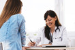© bnenin - Smiling female doctor having a conversation with patient