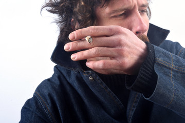 Portrait of a man smoking tobacco and coughing on white backgrou