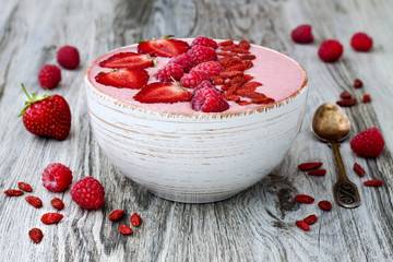 Poster - Pink acai, maca powder smoothie bowl  topped with sliced strawberries, raspberries and goji berries. Copy space. Valentines Day superfood aphrodisiac meal