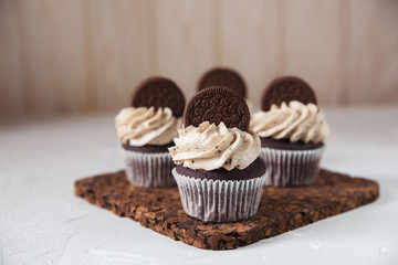 Homemade dark chocolate cupcakes with cookie and cream frosting