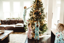Siblings Decorating Christmas Tree 