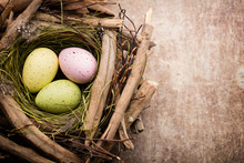 Easter Eggs In The Nest On Rustic Wooden Background