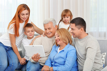 Poster - Happy family with tablet on couch