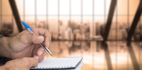 Poster - Composite image of close up of man writing in notepad
