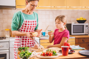 Wall Mural - Mother and daughter preparing pizza