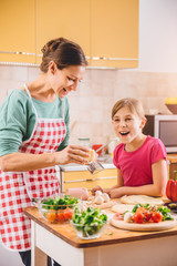 Wall Mural - Mother and daughter preparing pizza