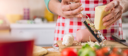 Wall Mural - Woman Grating Cheese