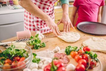 Wall Mural - Mother and daughter preparing pizza