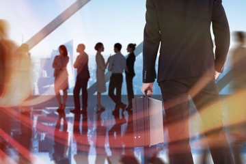 Poster - Composite image of rear view of businessman holding a briefcase