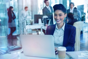 Poster - Businesswoman working on laptop in office