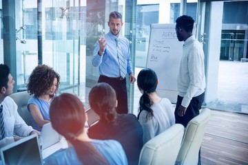 Poster - Businessman discussing on white board with coworkers