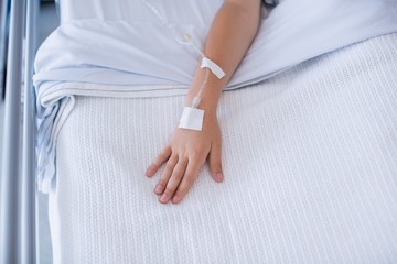 Canvas Print - Boy patient hand injected with saline iv drip