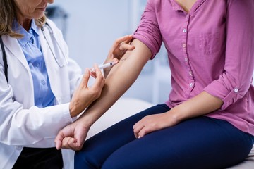 Wall Mural - Doctor giving an injection to the patient