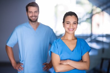 Wall Mural - Portrait of doctors standing with arms crossed