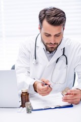 Wall Mural - Male doctor checking medicine