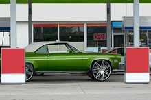 Green Antique Convertible At Gas Station