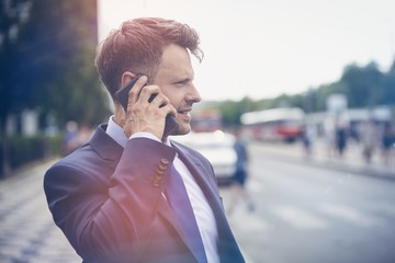 Handsome businessman speaking on mobile phone