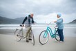 © WavebreakMediaMicro - Senior couple standing with bicycles on the beach