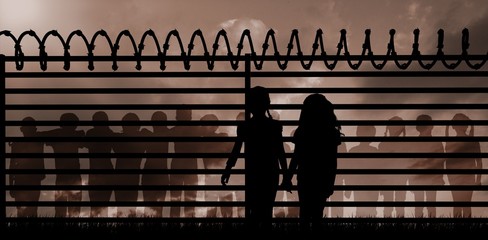 Wall Mural - Composite image of silhouette girls holding hands