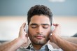 Man listening to music on headphones in living room