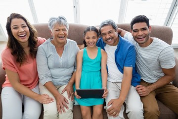 Wall Mural - Multi-generation family using digital tablet 