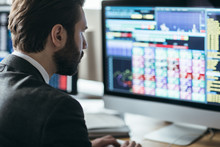 Man broker analyizing chart and stock market performance forecas