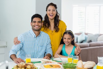 Poster - Daughter and parents having meal on table at home