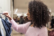 © DavidPrado - black woman shopping in a shopping center with bags