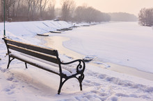 Wooden Bench In Snow.