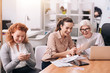 © zinkevych - Involved positive businesswomen creating the project at work