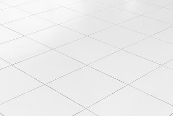 White tile floor background in perspective view. Clean, shiny, symmetry with grid line texture. For decoration in bathroom, kitchen and laundry room. And empty or copy space for product display also.