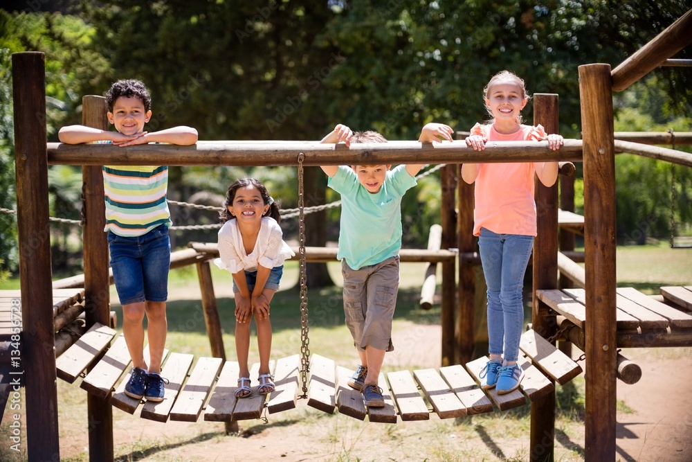 Kids standing and smiling on a playground ride in park Stock Photo ...