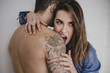 © LauraPeris/ADDICTIVE STOCK - Woman biting man's shoulder
