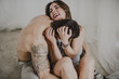 © ADDICTIVE STOCK - A playful couple sitting on the floor