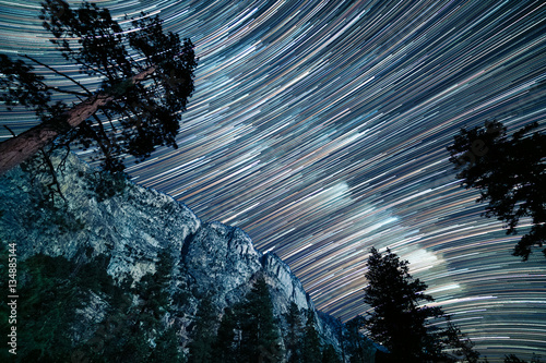 Long star trails of the milky way pass over the top of Kern canyon in a long exp Poster Mural XXL