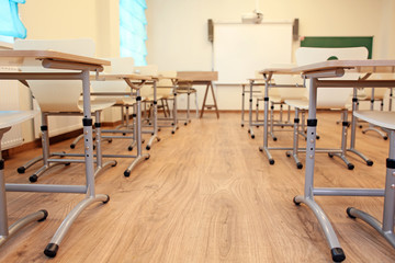 Sticker - Empty classroom with chairs and desks