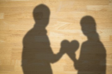 Poster - Composite image of couple holding a red heart