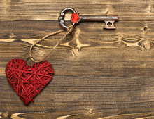 Red Heart And Metallic Key On Wood As Valentines Decoration