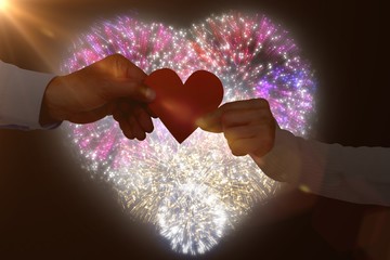 Poster - Composite image of couple holding paper heart shape paper