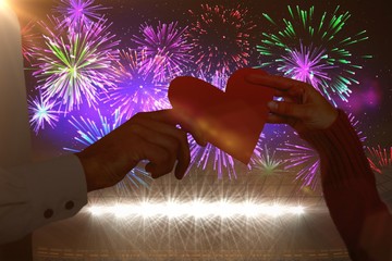 Poster - Composite image of couple hands holding heart shaped paper