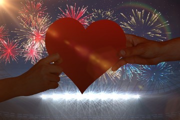 Poster - Composite image of hands holding red heart