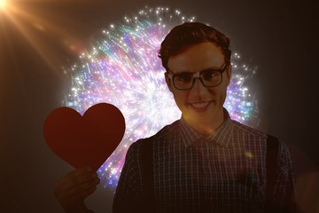 Poster - Composite image of geeky hipster holding a heart card