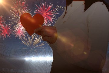 Poster - Composite image of midsection of woman holding heart shape paper