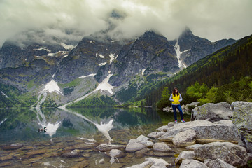 woman relaxing on the lake and mountains sunny landscape