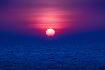 Wall Mural - Beautiful sunset over the sea, view from the beach. Round and br