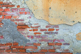 Fototapeta  - Old brick wall texture. Masonry background. Masonry texture. Brickwork with old bricks, deciduous plaster and pieces of mortar. Variegated run-down wall. Squalid bricken face. Shabby bricking sheet