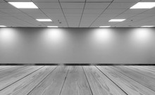 Perspective View Empty Space Monotone Black White Office Room With Row Ceiling LED Light Lamps And Lights Shade On Wall With Wooden Panel Floor For Gallery Interior / Mock Up Display Office Furniture